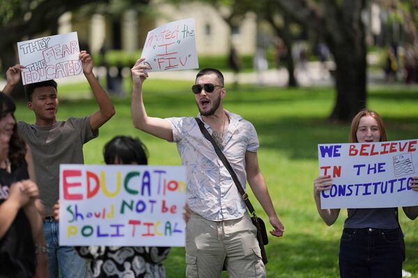 FILE - A group of Florida International University students protest against cuts in federal funding and an agreement by campus police to partner with Immigration and Customs Enforcement, on the FIU campus on a day of protests around the country in support of higher education, April 17, 2025, in Miami. (AP Photo/Rebecca Blackwell, File)