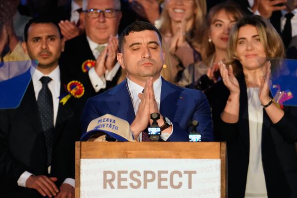 Presidential candidate George Simion speaks to media after polls closed for the second round of the country's presidential election redo in Bucharest, Romania, Sunday, May 18, 2025. (AP Photo/Vadim Ghirda)