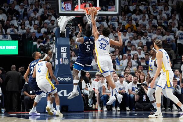 Minnesota Timberwolves guard Anthony Edwards (5) goes up for a shot as Golden State Warriors forward Trayce Jackson-Davis (32) defends during the first half of Game 2 of an NBA basketball second-round playoff series, Thursday, May 8, 2025, in Minneapolis. (AP Photo/Abbie Parr)