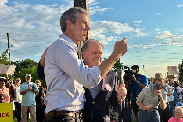 Former presidential candidate Beto O'Rourke of Texas speaks next to former U.S. Sen. Doug Jones of Alabama at a rally called "Tide Against Trump" in Tuscaloosa, Ala., held in opposition to President Donald Trump's appearance on campus on Thursday, May 1, 2025. (AP Photo/Kimberly Chandler)