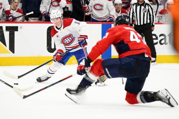 Montreal Canadiens right wing Cole Caufield (13) skates with the puck against Washington Capitals right wing Tom Wilson (43) in the second period of Game 5 of a first-round NHL hockey playoff series Wednesday, April 30, 2025, in Washington. (AP Photo/Nick Wass)