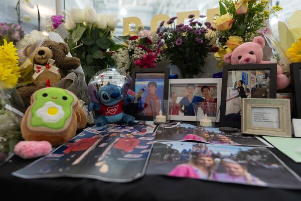 A memorial is seen along the boards at MedStar Capitals Iceplex Sunday, Feb. 2, 2025, in Arlington, Va., for the figure skaters who were among the 67 victims of a mid-air collision between an Army helicopter and an American Airlines flight from Kansas. (AP Photo/Carolyn Kaster)