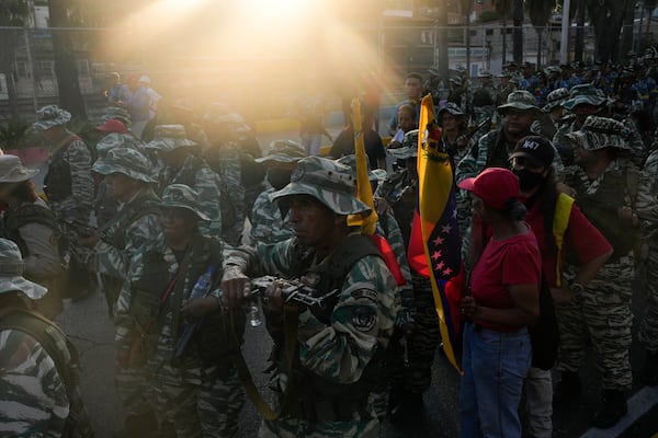 The sun shines onto a pro-government march in Caracas, Tuesday, Jan. 7, 2025, days ahead of President Nicolas Maduro's inauguration for a third term. (AP Photo/Matias Delacroix)