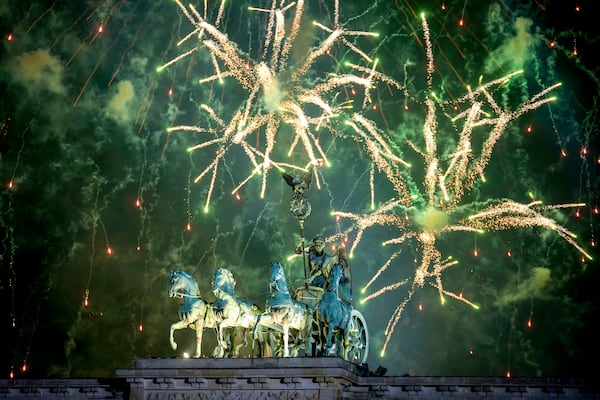 Fireworks light the sky above the Quadriga at the Brandenburg Gate during New Year's celebrations shortly after midnight in Berlin, Germany, Wednesday, Jan. 1, 2025. (AP Photo/Ebrahim Noroozi)