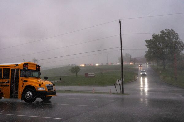 People leave the school as a storm begins at Fort Cherry High School in McDonald, Pa., Tuesday, April 29, 2025. (Lucy Schaly/Pittsburgh Post-Gazette via AP)