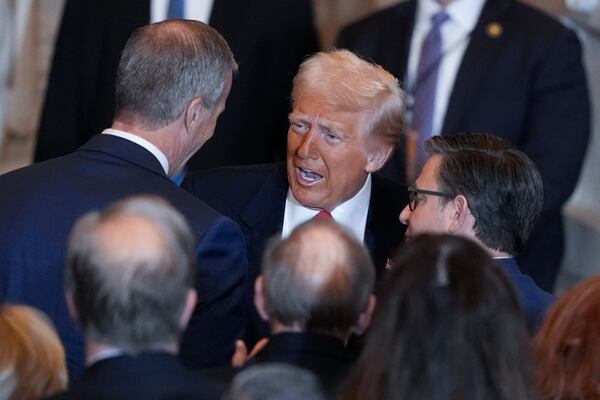 President Donald Trump talks to Senate Majority Leader John Thune, R-S.D., left and and House Speaker Mike Johnson, R-La., right, after he spoke to the National Prayer Breakfast, at the Capitol in Washington, Thursday, Feb. 6, 2025. (AP Photo/J. Scott Applewhite)