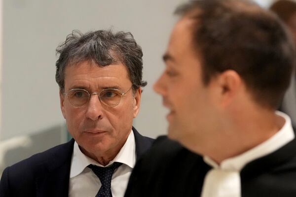 Alexandre Djouhri, left, a French-Algerian businessman, arrives to the courtroom as former French President Nicolas Sarkozy goes on trial over alleged illegal financing of his 2007 presidential campaign by the government of late Libyan leader Moammar Gadhafi, Monday, Jan. 6, 2025 in Paris. (AP Photo/Thibault Camus)