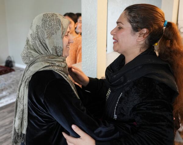 Pawlasha Rahimi, left, and Noria Sdeqi, who met weeks ago in a resettlement camp in Albania after leaving Afghanistan, hug after reuniting in Rancho Cordova, Calif., Wednesday, March 12, 2025. (AP Photo/Rich Pedroncelli)