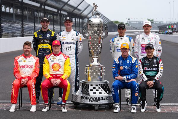 The former winners of the Indianapolis 500, top row, left to right, Alexander Rossi, Ryan Hunter-Reay, Helio Castroneves, of Brazil, and Marcus Ericsson, of Sweden, bottom bottom row, Will Power, of Australia, Josef Newgarden, Scott Dixon, of New Zealand, and Takuma Sato, of Japan, pose for a photo on the start/finish line before practice for the Indianapolis 500 auto race at the Indianapolis Motor Speedway in Indianapolis, Monday, May 19, 2025. (AP Photo/Michael Conroy)