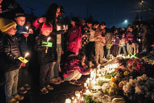 People gather at a vigil, March 22, 2024, in Renton, Wash., for the four people, Andrea Hudson, Matilda Wilcoxson, Eloise Wilcoxson and Boyd "Buster" Brown, who were killed in a car crash. (Ellen M. Banner/The Seattle Times via AP)