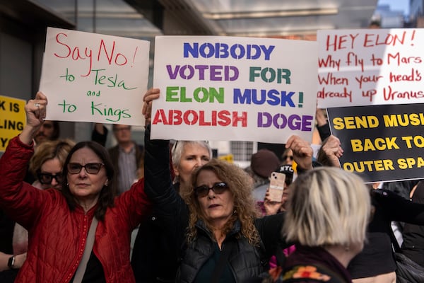 Demonstrators take part in a protest against Elon Musk and Tesla outside of a Tesla showroom, Saturday, March 01, 2025 in New York. (AP Photo/Adam Gray)