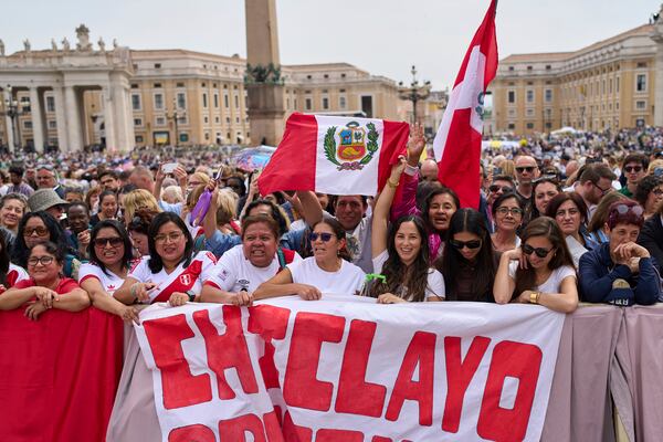 Faithful from Chiclayo, Peru, wave flags and react as Pope Leo XIV appears at the central balcony of St. Peter's Basilica for his first Sunday blessing after his election, in St. Peter's Square at the Vatican, Sunday, May 11, 2025.(AP Photo/Bernat Armangue)