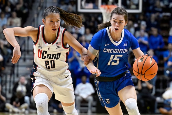 UConn's Kaitlyn Chen (20) guards against Creighton's Lauren Jensen (15) during the first half of an NCAA college basketball game in the finals of the Big East Conference tournament, Monday, March 10, 2025, in Uncasville, Conn. (AP Photo/Jessica Hill)