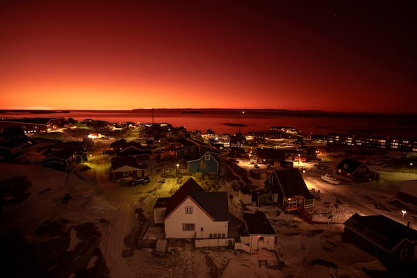 The sun sets in Ilulissat, Greenland, Tuesday, Feb. 18, 2025. (AP Photo/Emilio Morenatti)