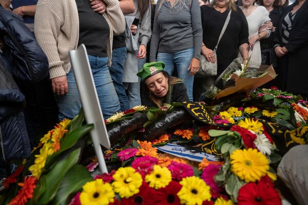 Gali the mother of the Israeli soldier Sergeant Yahav Maayan who was killed in combat in the Gaza Strip, reacts next to his son's grave during his funeral at a military cemetery in Modiin, Israel, Sunday, Jan. 12, 2025. (AP Photo/Ohad Zwigenberg)