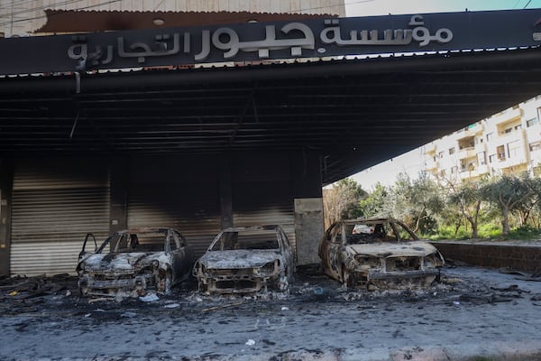 Burnt cars remain in an open garage following the recent wave of violence between Syrian security forces and gunmen loyal to former President Bashar Assad, as well as subsequent sectarian attacks, in the town of Jableh, Syria's coastal region, Monday, March 10, 2025. (AP Photo/Omar Albam)