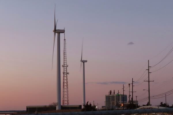 FILE - The sun sets behind a land-based wind farm in Atlantic City, N.J., on Feb. 10, 2022. (AP Photo/Wayne Parry, File)