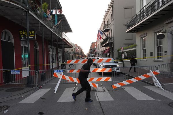 A police barricade near the scene after a vehicle drove into a crowd on New Orleans' Canal and Bourbon Street, Wednesday Jan. 1, 2025. (AP Photo/Gerald Herbert)