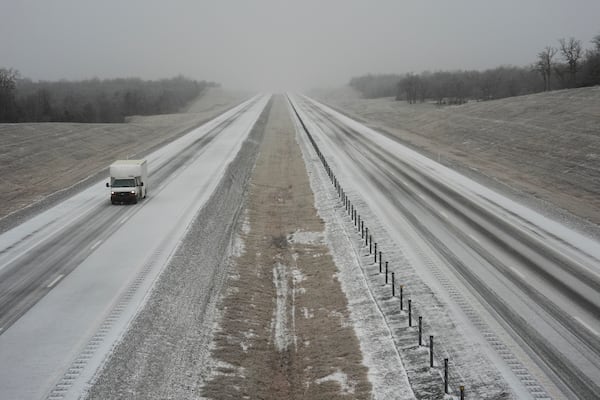 A truck drives along Interstate 335 during a winter storm, Tuesday, Feb. 18, 2025, near Luther, Okla. (AP Photo/Joshua A. Bickel)