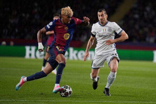 Barcelona's Lamine Yamal, left, and Inter Milan's Henrikh Mkhitaryan fight for the ball during the Champions League semifinal first leg soccer match between Barcelona and Inter Milan in Barcelona, Spain, Wednesday, April 30, 2025. AP Photo/Emilio Morenatti)