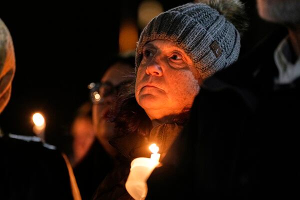 Supporters hold candles during a candlelight vigil Tuesday, Dec. 17, 2024, outside the Wisconsin Capitol in Madison, Wis., following a shooting at the Abundant Life Christian School on Monday, Dec. 16. (AP Photo/Morry Gash)