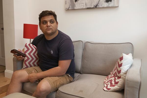 Spencer Goidel, an Equal Employment Opportunity Specialist with the Internal Revenue Service who was notified his job would be eliminated as part of the government's efficiency cuts, sits for a portrait in his home in Boca Raton, Fla., April 16, 2025. (AP Photo/Daniel Kozin)