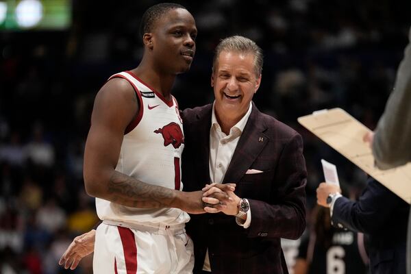 Arkansas guard Johnell Davis (1) speaks with Arkansas head coach John Calipari after a win over South Carolina during an NCAA college basketball game at the Southeastern Conference tournament, Wednesday, March 12, 2025, in Nashville, Tenn. (AP Photo/George Walker IV)