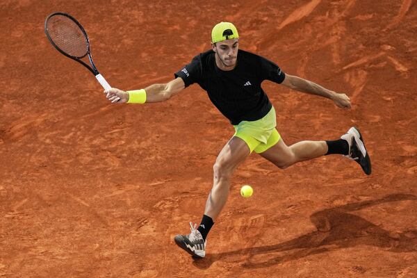 Francisco Cerundolo from Argentina returns the ball against Casper Ruud of Norway during men's semifinal at the Madrid Open tennis tournament in Madrid, Spain, Friday, May 2, 2025. (AP Photo/Manu Fernandez)