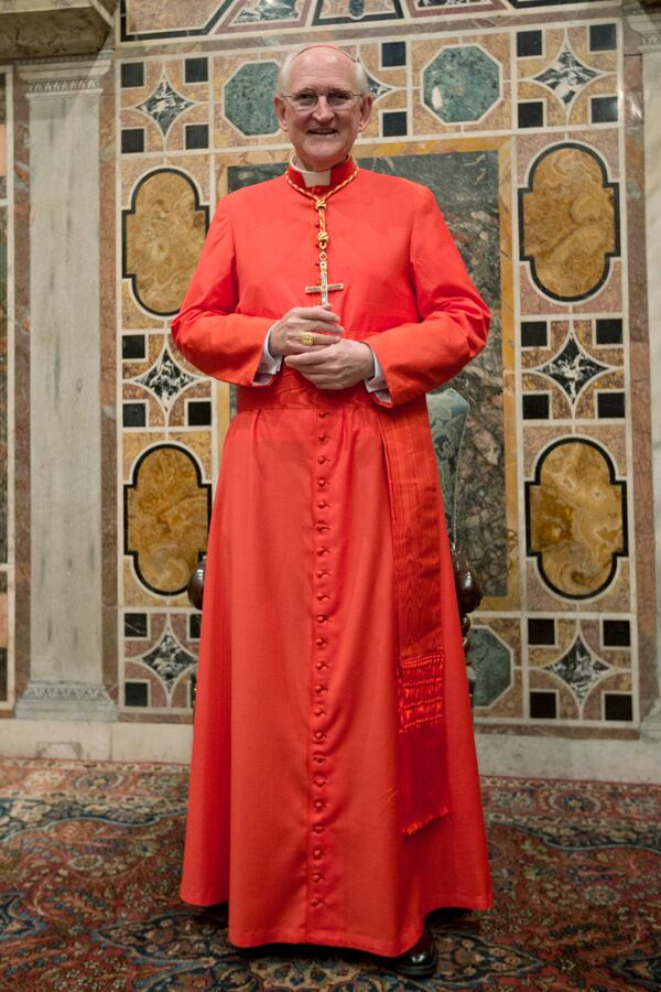 FILE - Newly-elected Cardinal James Michael Harvey from the U.S. poses for photographers prior to meeting relatives and friends after he was elevated to cardinal by Pope Benedict XVI, at the Vatican during a consistory, Nov. 24, 2012. (AP Photo/Andrew Medichini, File)