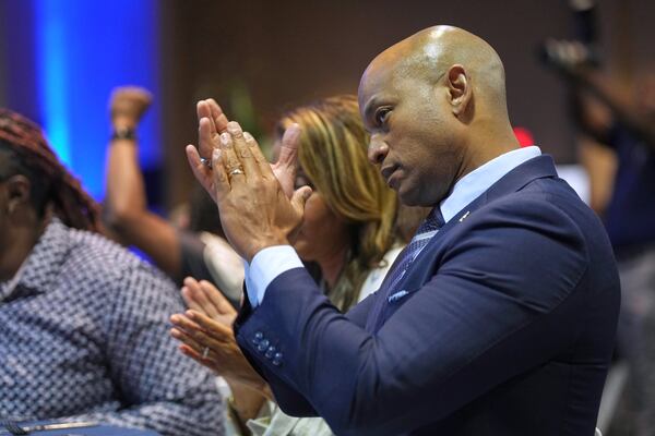 Maryland Gov. Wes Moore applauds as former Democratic National Committee Chair Jaime Harrison speaks at the South Carolina Democratic Party's Blue Palmetto Dinner Friday, May 30, 2025, in Columbia, S.C. (AP Photo/Meg Kinnard)
