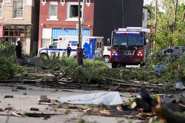 People survey damage after a severe storm moved through Friday, May 16, 2025, in St. Louis. (AP Photo/Jeff Roberson)