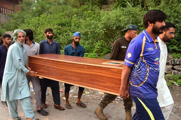 Volunteers carry a body after recovering it from the rubble of a mosque building damaged by a suspected Indian missile attack near Muzaffarabad, the capital of Pakistan controlled Kashmir, on Wednesday, May 7, 2025. (AP Photo/M.D. Mughal)