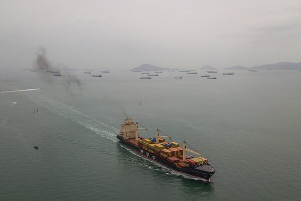 A cargo ship sails towards the Pacific Ocean waiting to transit the Panama Canal in Panama City, Saturday, Feb. 1, 2025. (AP Photo/Matias Delacroix)