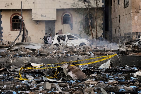 Locals inspect the site reportedly struck by U.S. airstrikes overnight in Sanaa, Yemen, Thursday, March 20, 2025. (AP Photo)