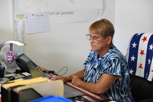 Cheryl Tillman, mayor of Gateway, Ark., and sister of James Appleton, who was fatally shot in 2017, works on her laptop at Town Hall on May 28, 2026. Grant Hardin, who briefly served as police chief, pleaded guilty to first-degree murder. (AP Photo/Nick Ingram)