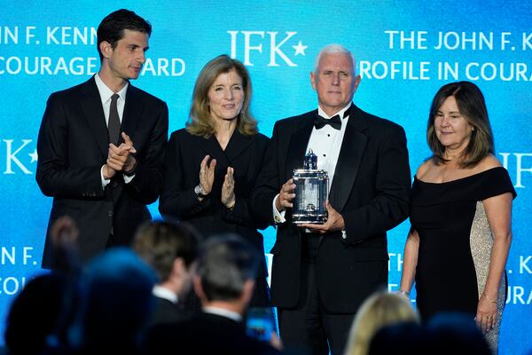 Former Vice President Mike Pence, second from right, stands with his wife, Karen Pence, far right, as he is presented with the John F. Kennedy Profile in Courage Award by Jack Schlossberg and his mother, Caroline Kennedy, at a ceremony at the JFK Library, Sunday, May 4, 2025, in Boston. (AP Photo/Robert F. Bukaty)