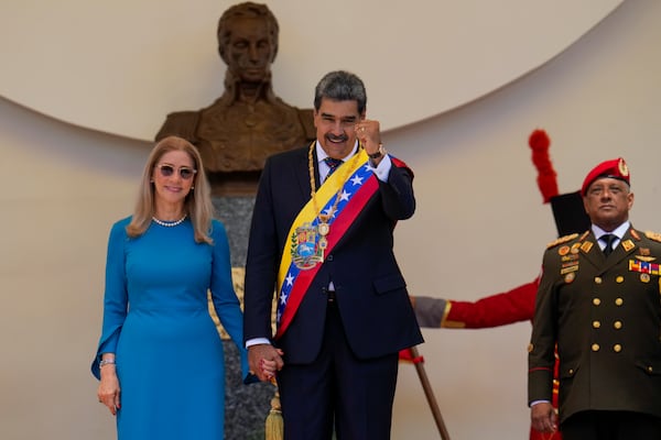 Venezuelan President Nicolas Maduro and his wife Cilia Flores stand at the National Assembly after his swearing-in ceremony for a third term in Caracas, Venezuela, Friday, Jan. 10, 2025. (AP Photo/Ariana Cubillos)