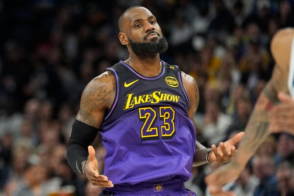 Los Angeles Lakers forward LeBron James reacts after missing a basket during the first half of an NBA basketball game against the Minnesota Timberwolves, Monday, Dec. 2, 2024, in Minneapolis. (AP Photo/Abbie Parr)