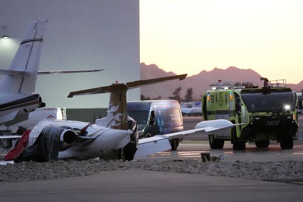 A crashed Learjet sits next to a plane it collided with as Scottsdale Airport Fire Deapartment vehicle sits nearby at Scottsdale Airport Monday, Feb. 10, 2025, in Scottsdale, Ariz. (AP Photo/Ross D. Franklin)