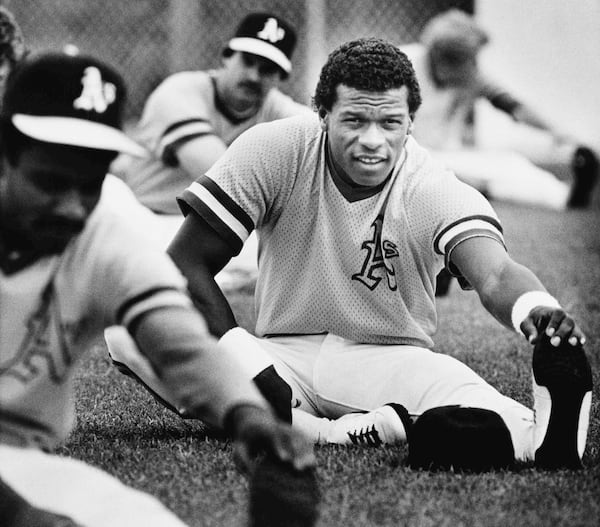 FILE - Rickey Henderson, the Oakland Athletics record-setting base stealer, stretches during his first workout at Oakland's Phoenix spring training camp Feb. 27, 1983. (AP Photo/Sal Veder, File)