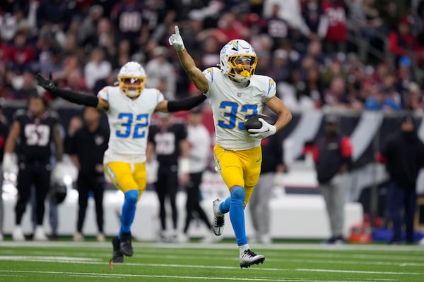 Los Angeles Chargers cornerback Deane Leonard (33) celebrates after intercepting a pass against the Houston Texans during the first half of an NFL wild-card playoff football game Saturday, Jan. 11, 2025, in Houston. (AP Photo/Eric Christian Smith)