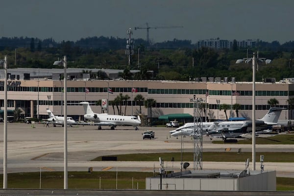 The plane carrying influencer brothers Andrew and Tristan Tate have arrives in Fort Lauderdale, Fla. from Romania on Thursday, Feb. 27, 2025. (AP Photo/Jennifer Lett)