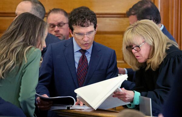 Defense attorney Robert Alessi, center, confers with Superior Court Judge Beverly Cannone as Karen Read, left, stands by during a sidebar during Read's murder trial at Norfolk Superior Court, Tuesday, May 27, 2025, in Dedham, Mass. (Matt Stone/The Boston Herald via AP, Pool)
