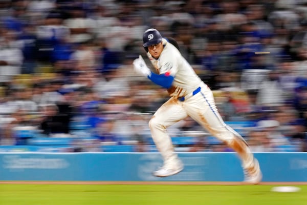 FILE - Los Angeles Dodgers' Shohei Ohtani runs from first on his way to stealing second during the ninth inning of a baseball game against the Colorado Rockies, Saturday, Sept. 21, 2024, in Los Angeles. (AP Photo/Mark J. Terrill, File)