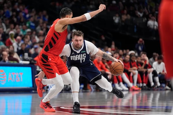 Dallas Mavericks guard Luka Doncic drives against Portland Trail Blazers forward Toumani Camara during the second half of an NBA basketball game, Monday, Dec. 23, 2024, in Dallas. (AP Photo/LM Otero)