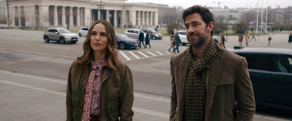 This image released by Apple TV+ shows Natalie Portman, left, and John Krasinski in a scene from the film "Fountain of Youth." (Apple TV+ via AP)