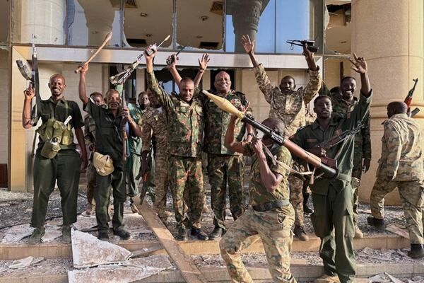 In this picture released by Sudanese Armed Forces (SAF) in social media, soldiers celebrate after taking over the Republican Palace in Khartoum, Sudan, Friday March 21, 2025. (SAF via AP )