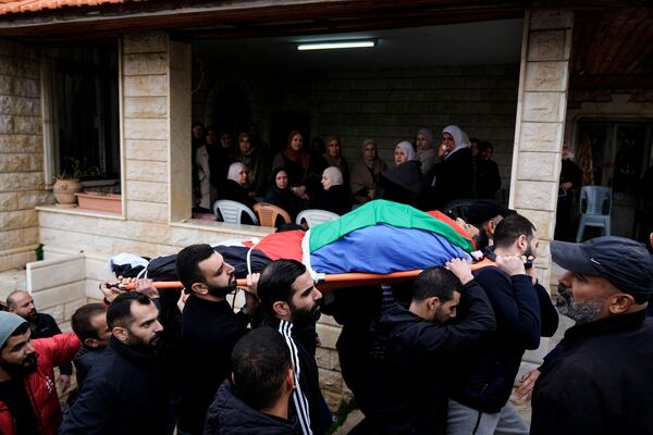 Mourners carry the body of Ahmad Nimer Al-Shaib after he was killed during an Israeli military operation in Jenin, in the West Bank village of Bruqin, Wednesday, Jan. 22, 2025. (AP Photo/Majdi Mohammed)