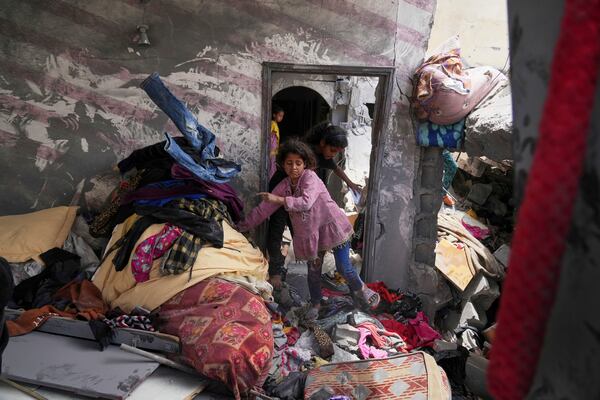 Palestinian children search for belongings in a house damaged by an Israeli army strike that killed at least five people in Khan Younis, in the southern Gaza Strip, Thursday, May 1, 2025. (AP Photo/Abdel Kareem Hana)