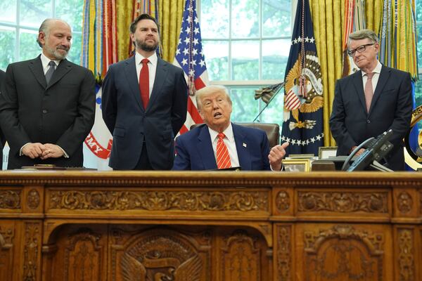 President Donald Trump, center, with from l-r., Commerce Secretary Howard Lutnick, Vice President JD Vance, and Britian's ambassador to the United States Peter Mandelson, making remarks on a trade deal between U.S. and U.K. in the Oval Office of the White House, Thursday, May 8, 2025, in Washington. (AP Photo/Evan Vucci)
